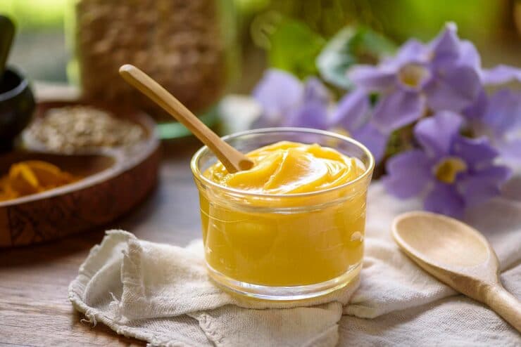 ghee butter glass jar with wooden spoon wood — desi ghee for skin and hair article image