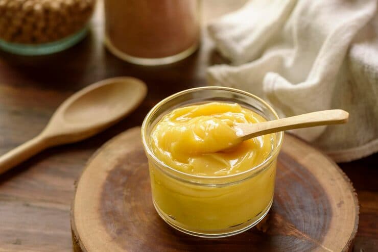 ghee butter glass jar with wooden spoon wood — desi ghee for skin and hair article image