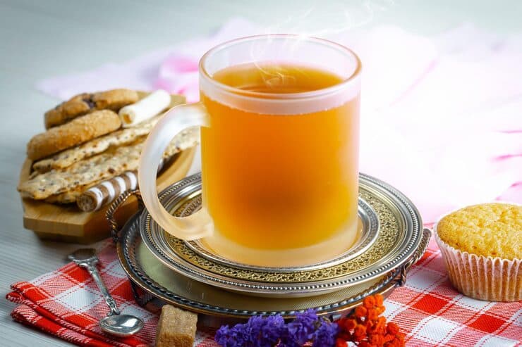cup tea sits plate with few cookies it 23179 — desi ghee in morning article image