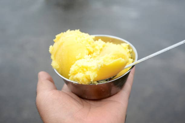 closeup the yellow clarified butter in the s — what is desi ghee article image